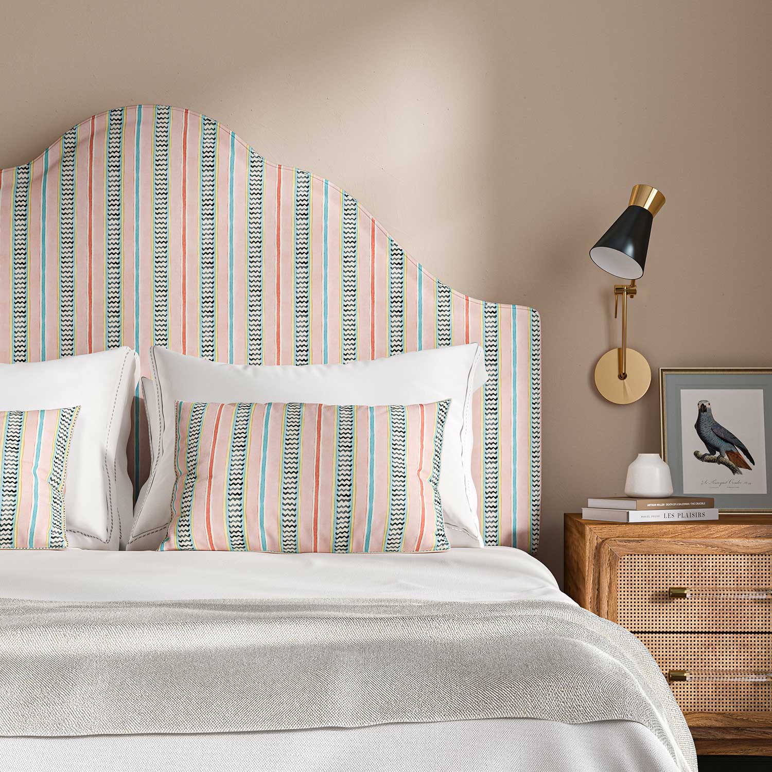Headboard in a multicoloured – pink, red and blue – printed linen fabric featuring stripes, wavy edges and zigzags.
