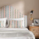 Headboard in a multicoloured – pink, red and blue – printed linen fabric featuring stripes, wavy edges and zigzags.