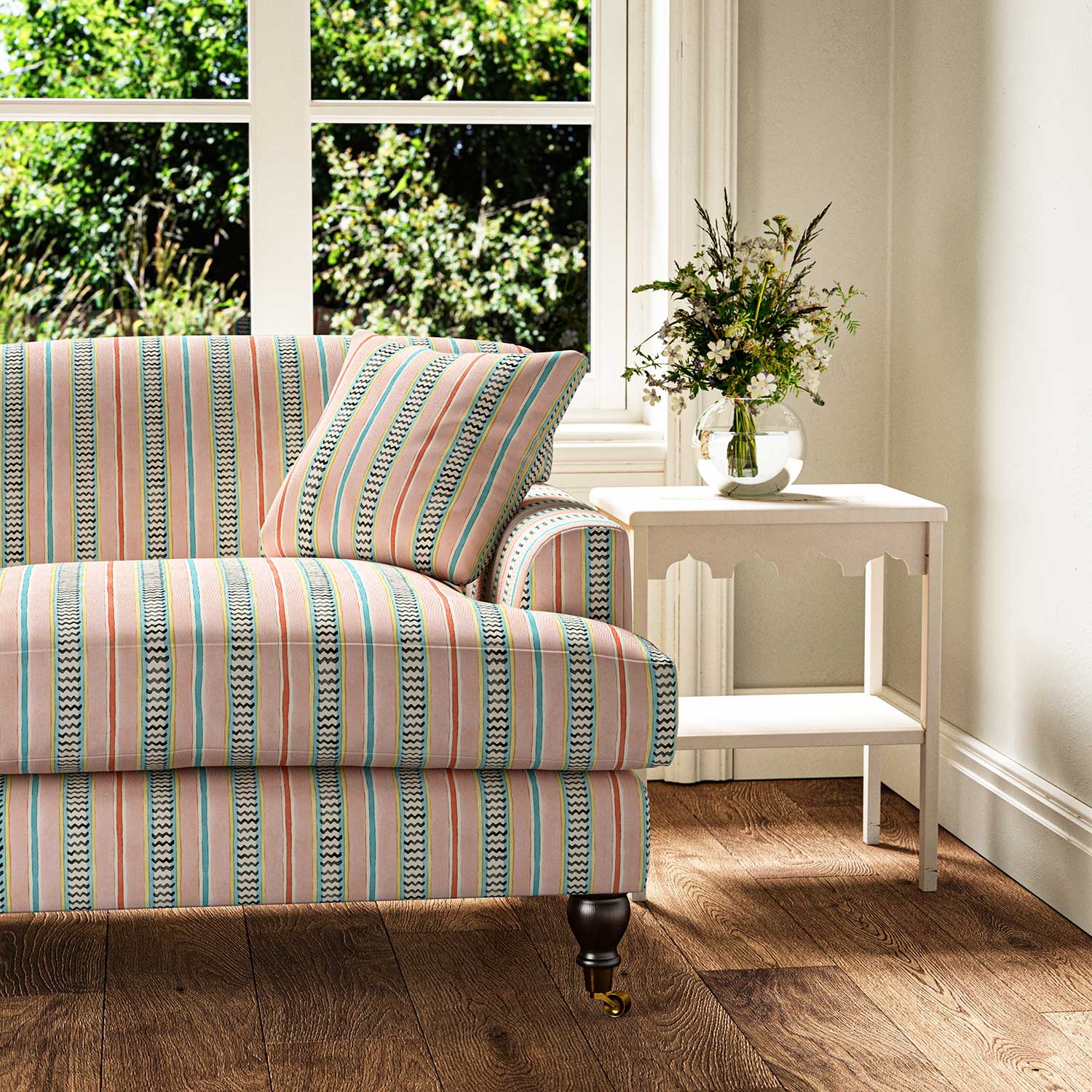 Sofa in a multicoloured – pink, red and blue – printed linen fabric featuring stripes, wavy edges and zigzags.