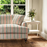 Sofa in a multicoloured – pink, red and blue – printed linen fabric featuring stripes, wavy edges and zigzags.