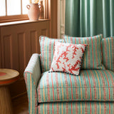 Armchair in a multicoloured – blue, red and pink – printed linen fabric featuring stripes, wavy edges and zigzags.