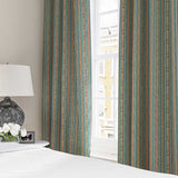 Curtains in a multicoloured – blue, red and pink – printed linen fabric featuring stripes, wavy edges and zigzags.