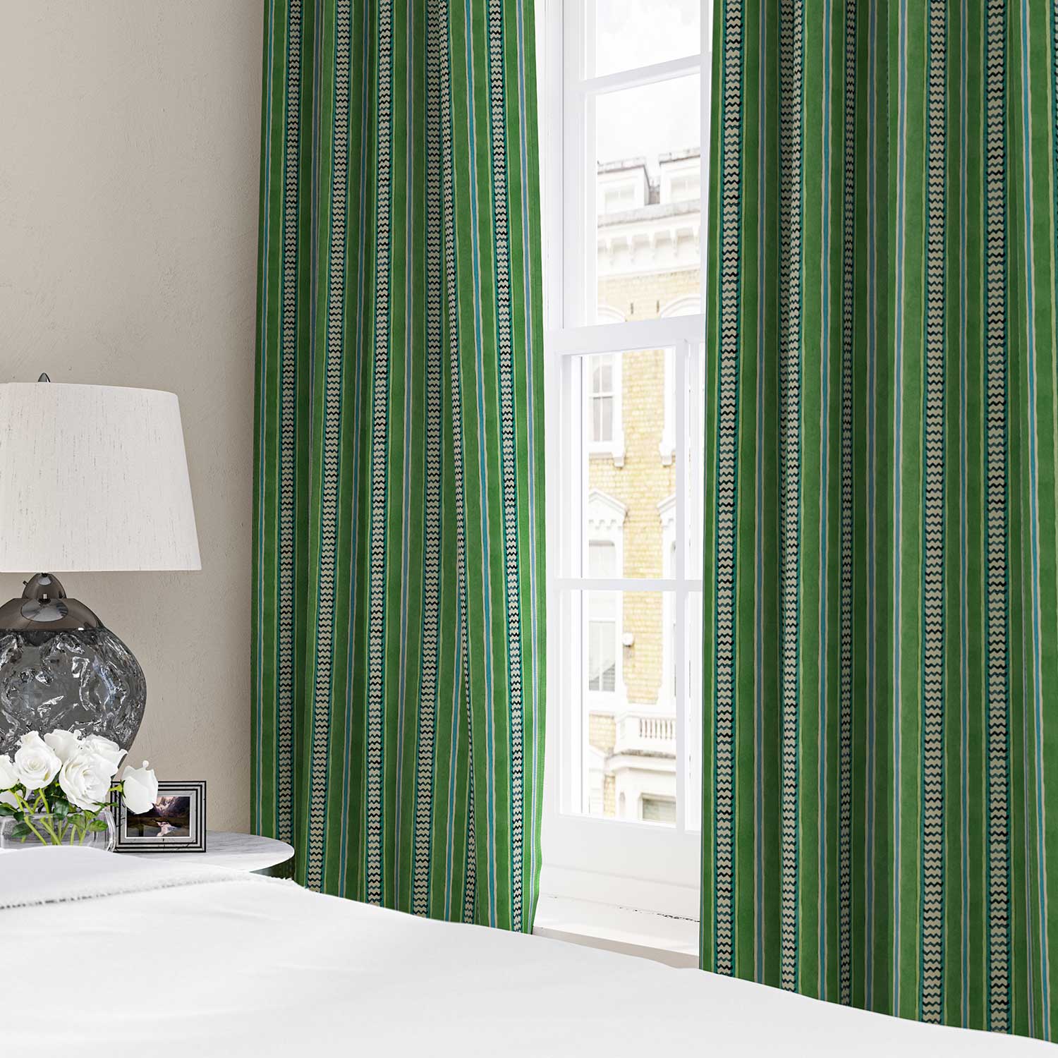 Curtains in a multicoloured – green and blue – printed linen fabric featuring stripes, wavy edges and zigzags.