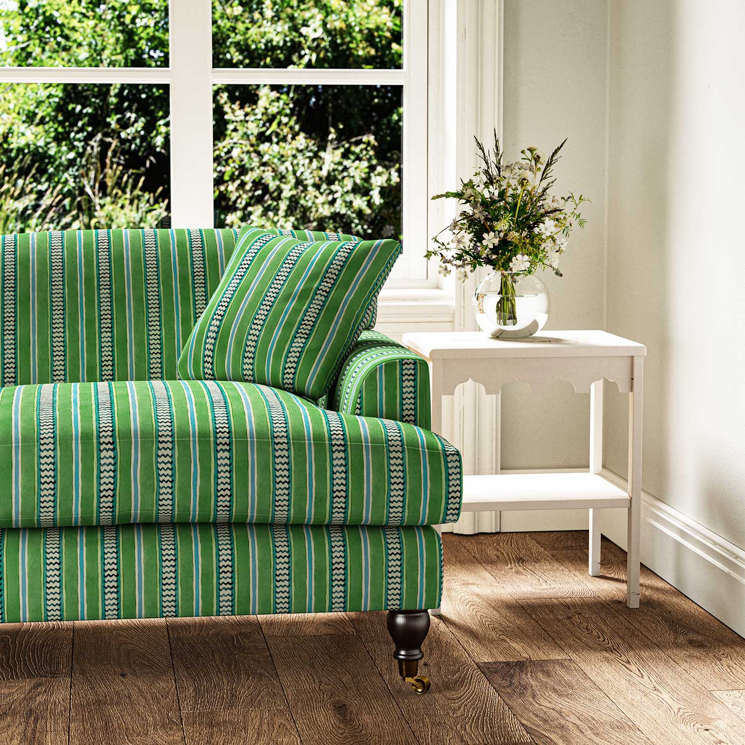 Sofa in a multicoloured – green and blue – printed linen fabric featuring stripes, wavy edges and zigzags.
