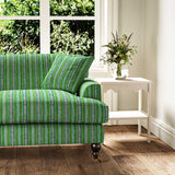 Sofa in a multicoloured – green and blue – printed linen fabric featuring stripes, wavy edges and zigzags.