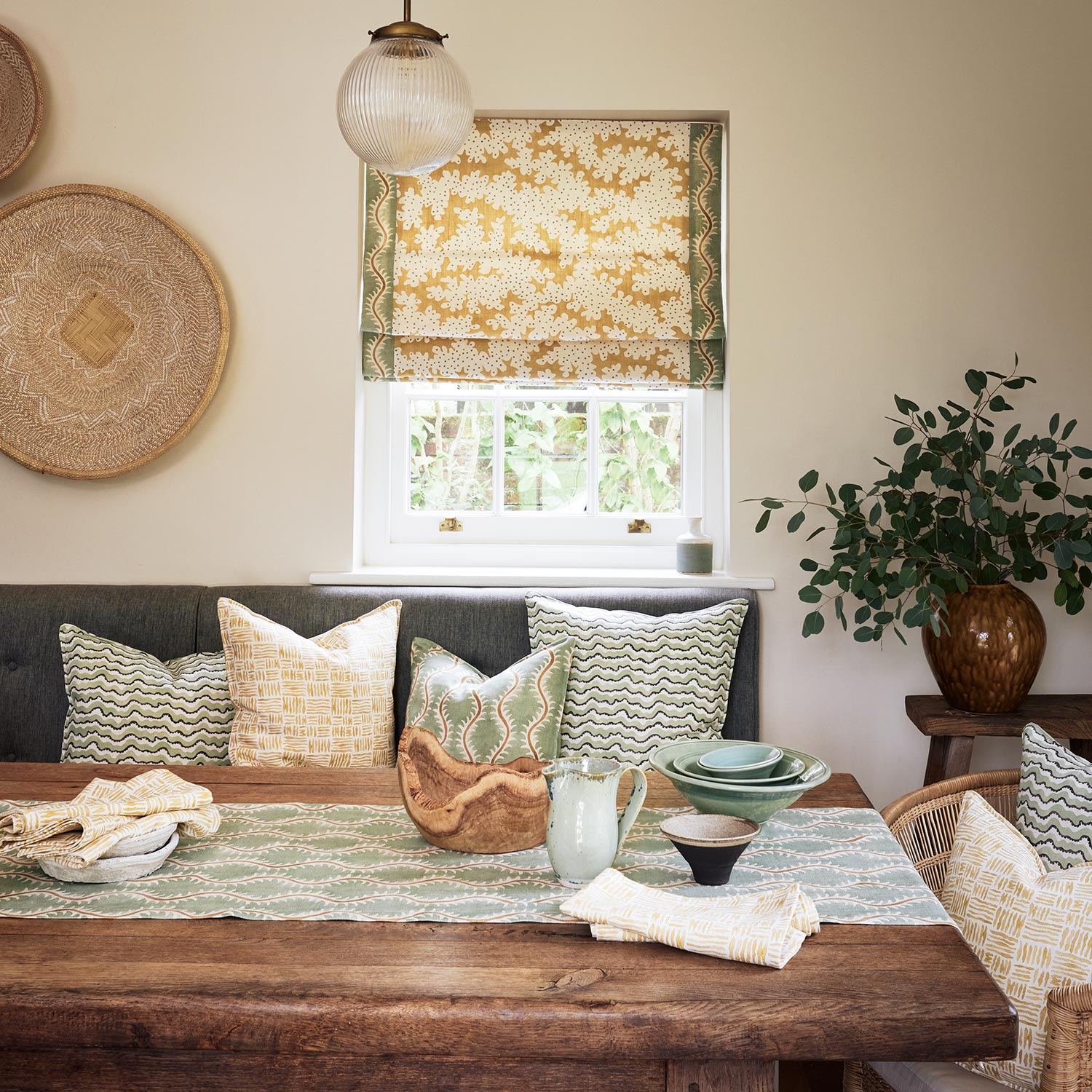 Blind made from a printed linen fabric sample in yellow, blue and off white featuring a stylized coral pattern.