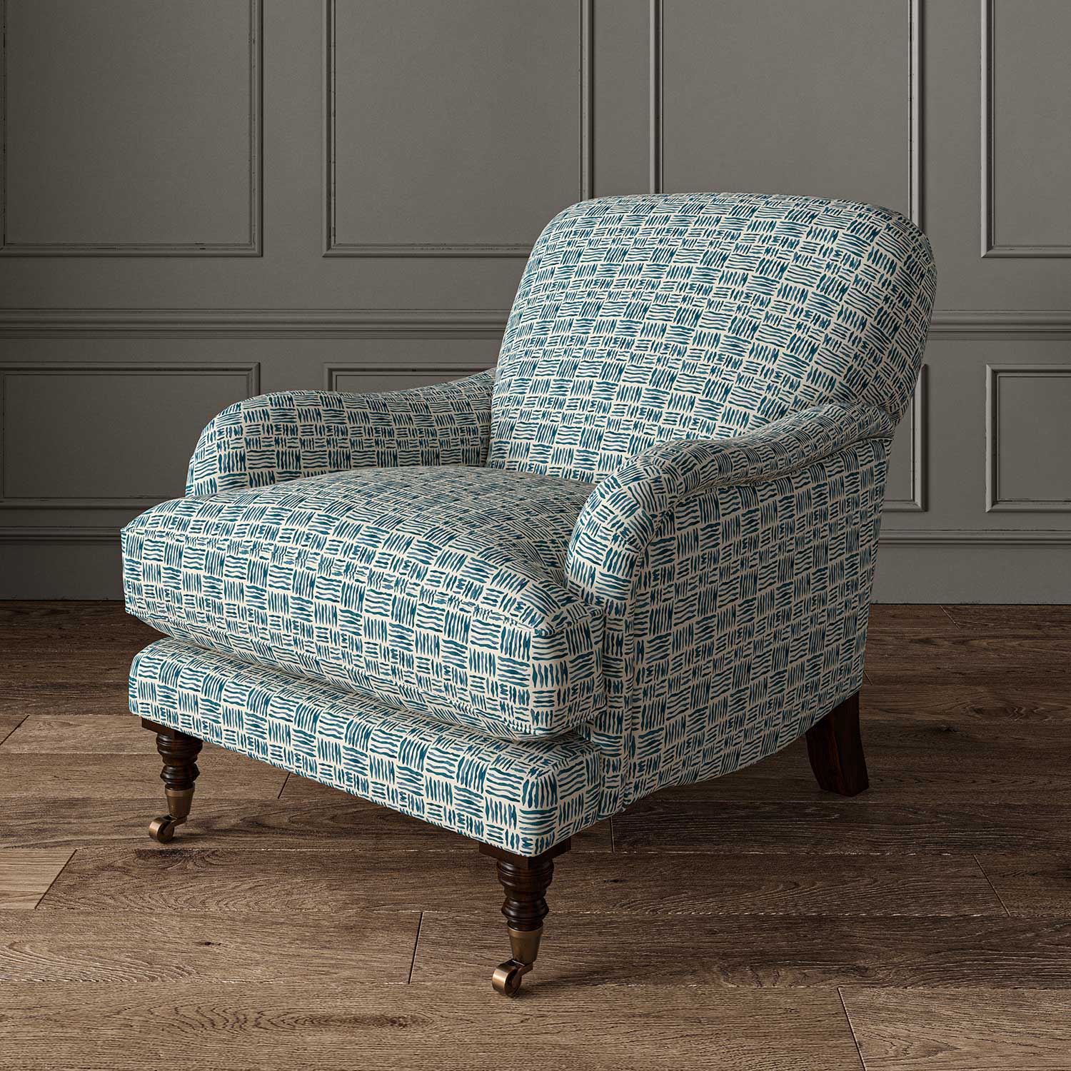 Chair upholstered in a printed linen fabric in blue and off white featuring a basketweave pattern.