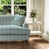 Sofa upholstered in a printed linen fabric in blue and off white featuring a basketweave pattern.