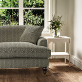 Sofa upholstered in a printed linen fabric in black, brown and off white featuring a sound wave pattern