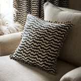 Cushion made from a printed linen fabric in black, brown and off white featuring a sound wave pattern