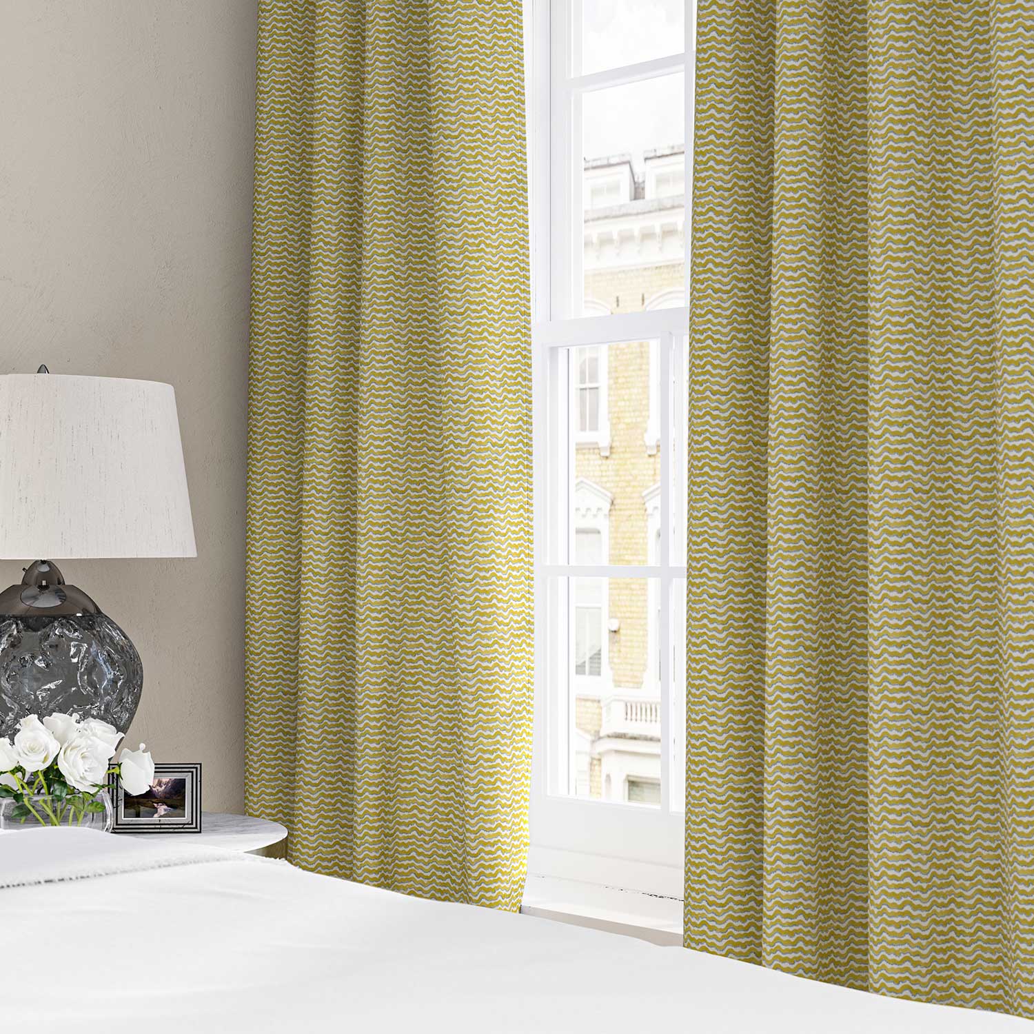 Curtains made from a printed linen fabric sample in yellow, blue and off white featuring a sound wave pattern