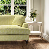 Sofa upholstered in a printed linen fabric sample in yellow, blue and off white featuring a sound wave pattern