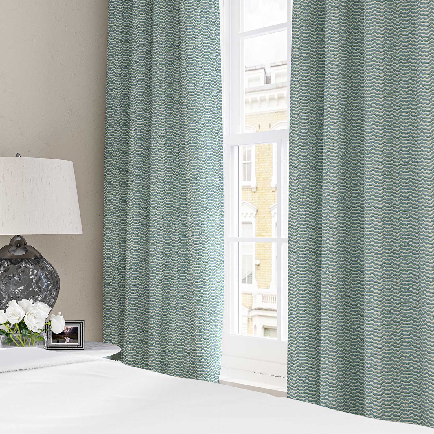 Curtains made from a printed linen fabric in blue, green and off white featuring a sound wave pattern