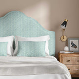 Headboard upholstered in a printed linen fabric in blue, green and off white featuring a sound wave pattern