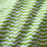 A printed linen fabric sample in blue, green and off white featuring a sound wave pattern