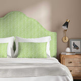 Headboard upholstered in a printed linen fabric in blue, green and off white featuring a sound wave pattern