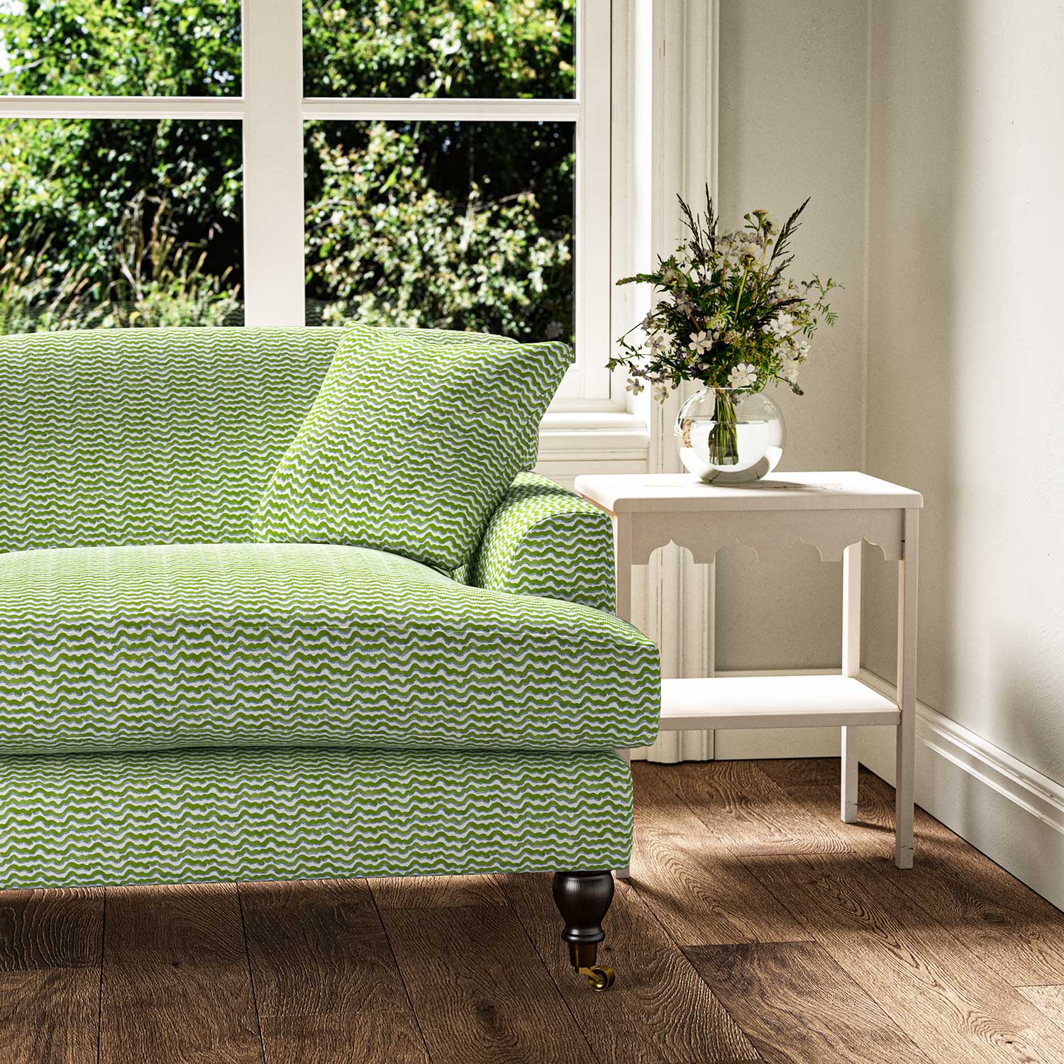 Sofa upholstered in a printed linen fabric in blue, green and off white featuring a sound wave pattern