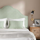 Headboard upholstered in a printed linen fabric in green, black and off white featuring a sound wave pattern