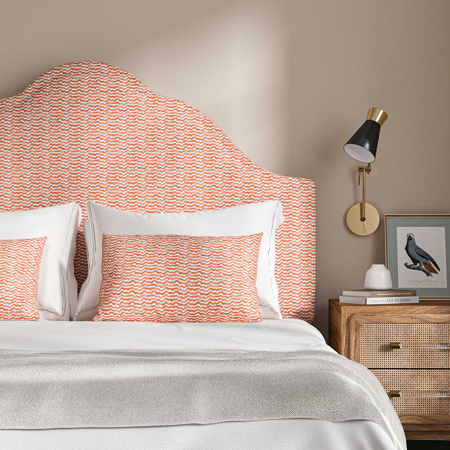 Headboard upholstered in printed linen fabric sample in a red, blue and off white featuring a sound wave pattern