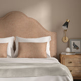 Woven Salmon coloured fabric on a headboard