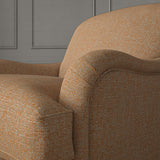 Woven orange coloured fabric on a chair