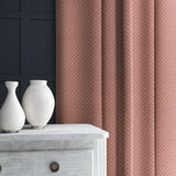 Curtain in red and off-white woven fabric featuring a trellis pattern.