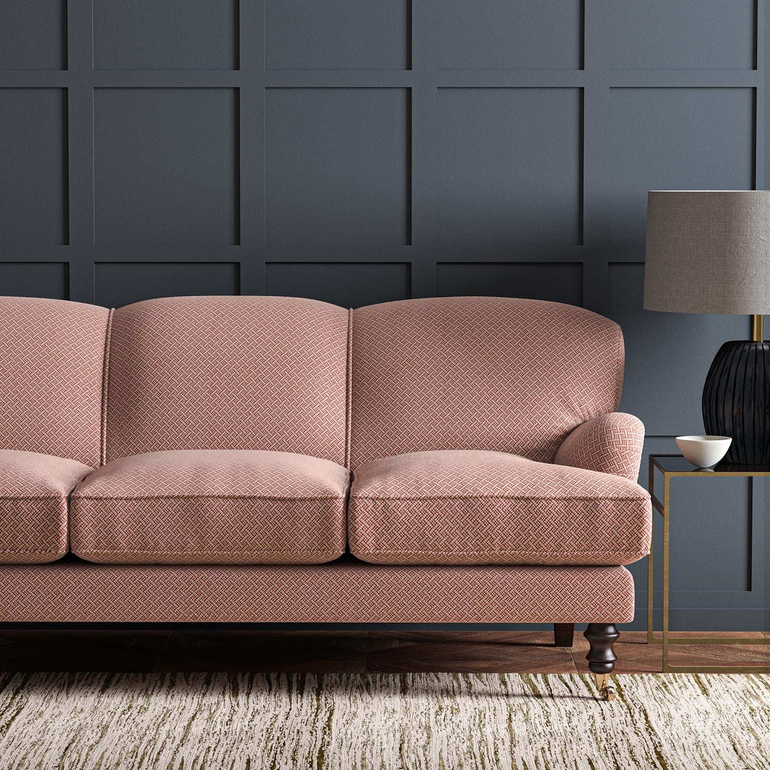 Sofa upholstered in a red and off-white woven fabric featuring a trellis pattern.
