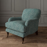 Chair upholstered in a blue and off-white woven fabric featuring a geometric pattern.