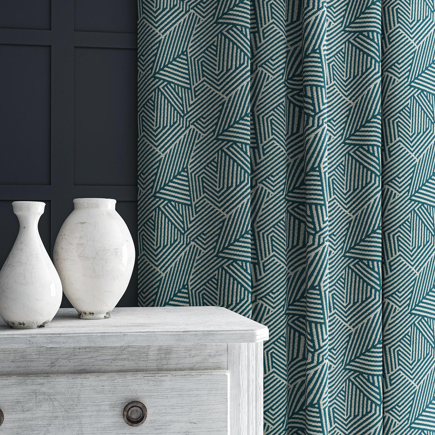 Curtain in blue and off-white woven fabric featuring a geometric pattern.