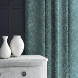 Curtain in blue and off-white woven fabric featuring a geometric pattern.