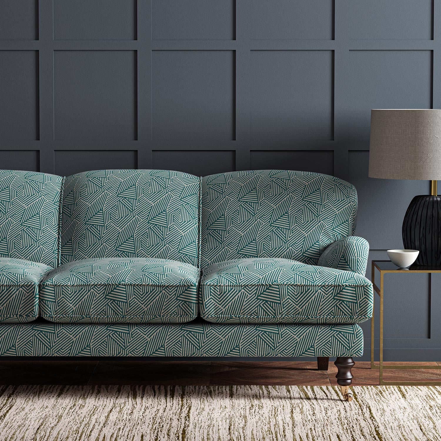 Sofa upholstered in a blue and off-white woven fabric featuring a geometric pattern.