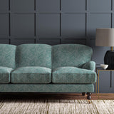 Sofa upholstered in a blue and off-white woven fabric featuring a geometric pattern.