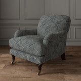 Chair upholstered in a blue and off-white woven fabric featuring a geometric pattern.