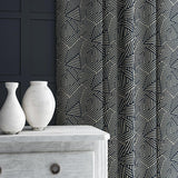 Curtain in blue and off-white woven fabric featuring a geometric pattern.