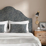 Headboard upholstered in a blue and off-white woven fabric featuring a geometric pattern.