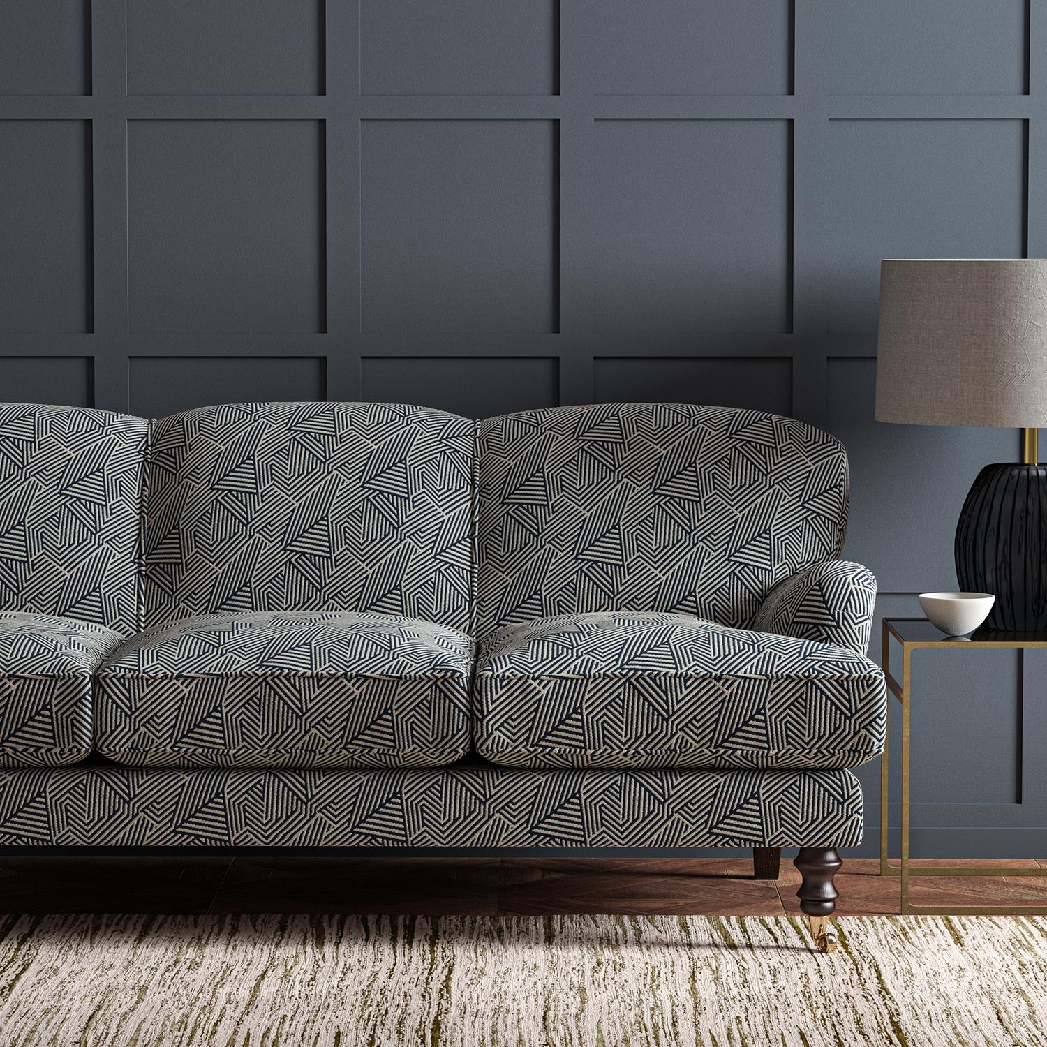 Sofa upholstered in a blue and off-white woven fabric featuring a geometric pattern.