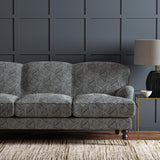 Sofa upholstered in a blue and off-white woven fabric featuring a geometric pattern.