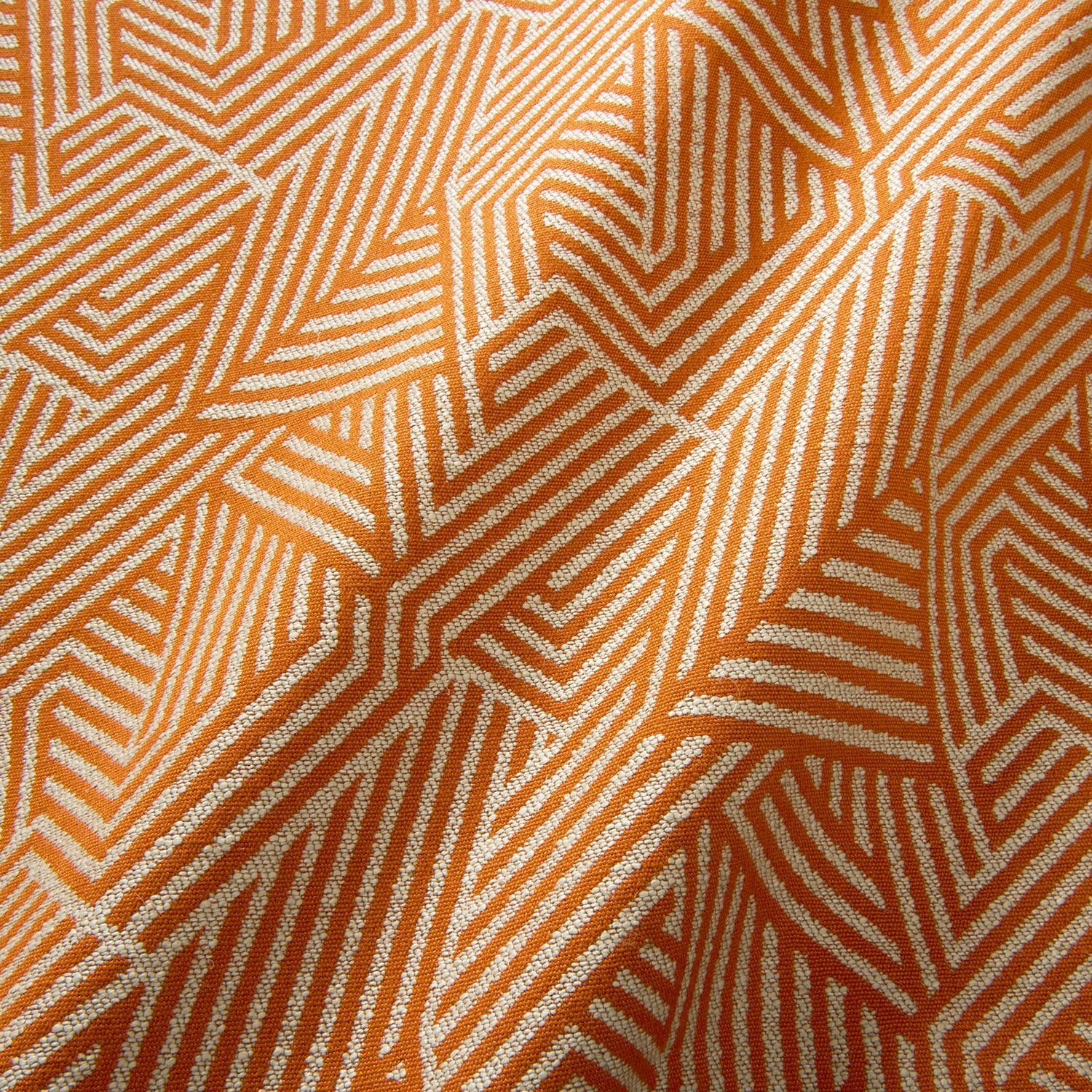 A woven fabric sample in orange and off-white featuring a geometric pattern.