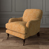 Chair upholstered in a orange and off-white woven fabric featuring a geometric pattern.