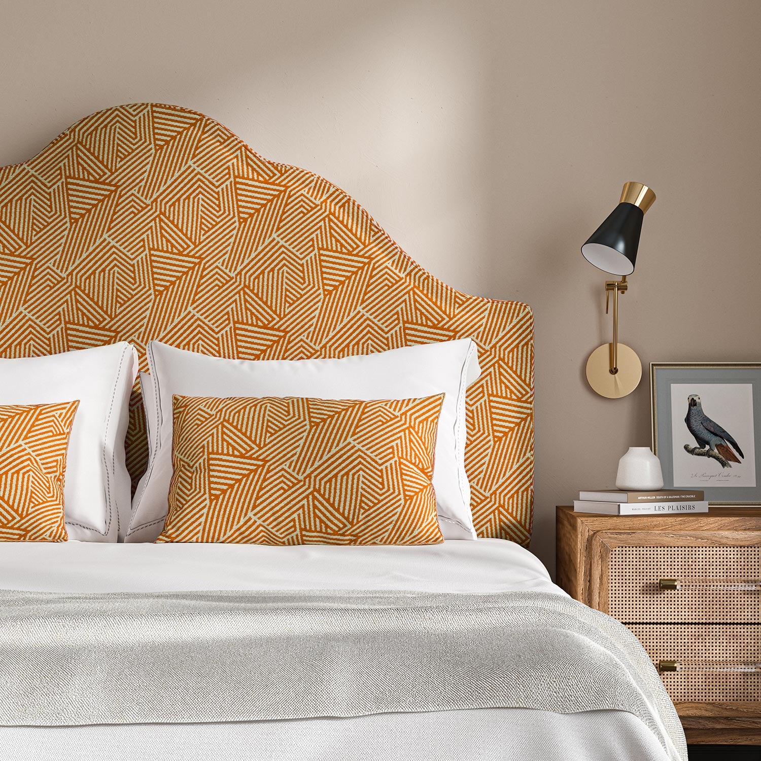 Headboard upholstered in a orange and off-white woven fabric featuring a geometric pattern.