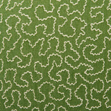 A woven fabric sample in green and off-white featuring a wavy pattern.