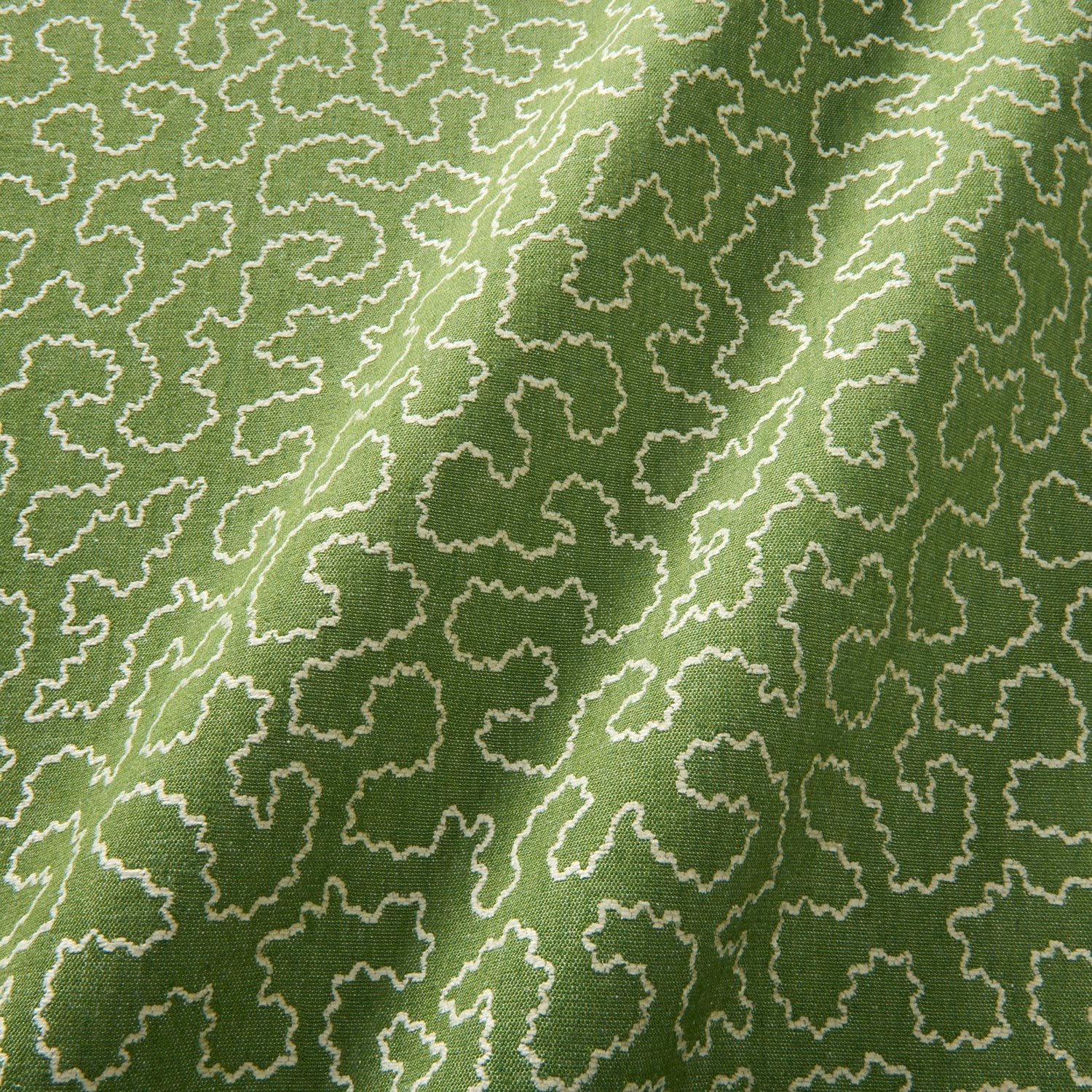 A woven fabric sample in green and off-white featuring a wavy pattern.