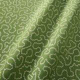 A woven fabric sample in green and off-white featuring a wavy pattern.