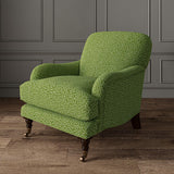 Chair upholstered in a green and off-white woven fabric featuring a wavy pattern.