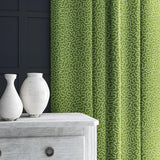 Curtain in green and off-white woven fabric featuring a wavy pattern.
