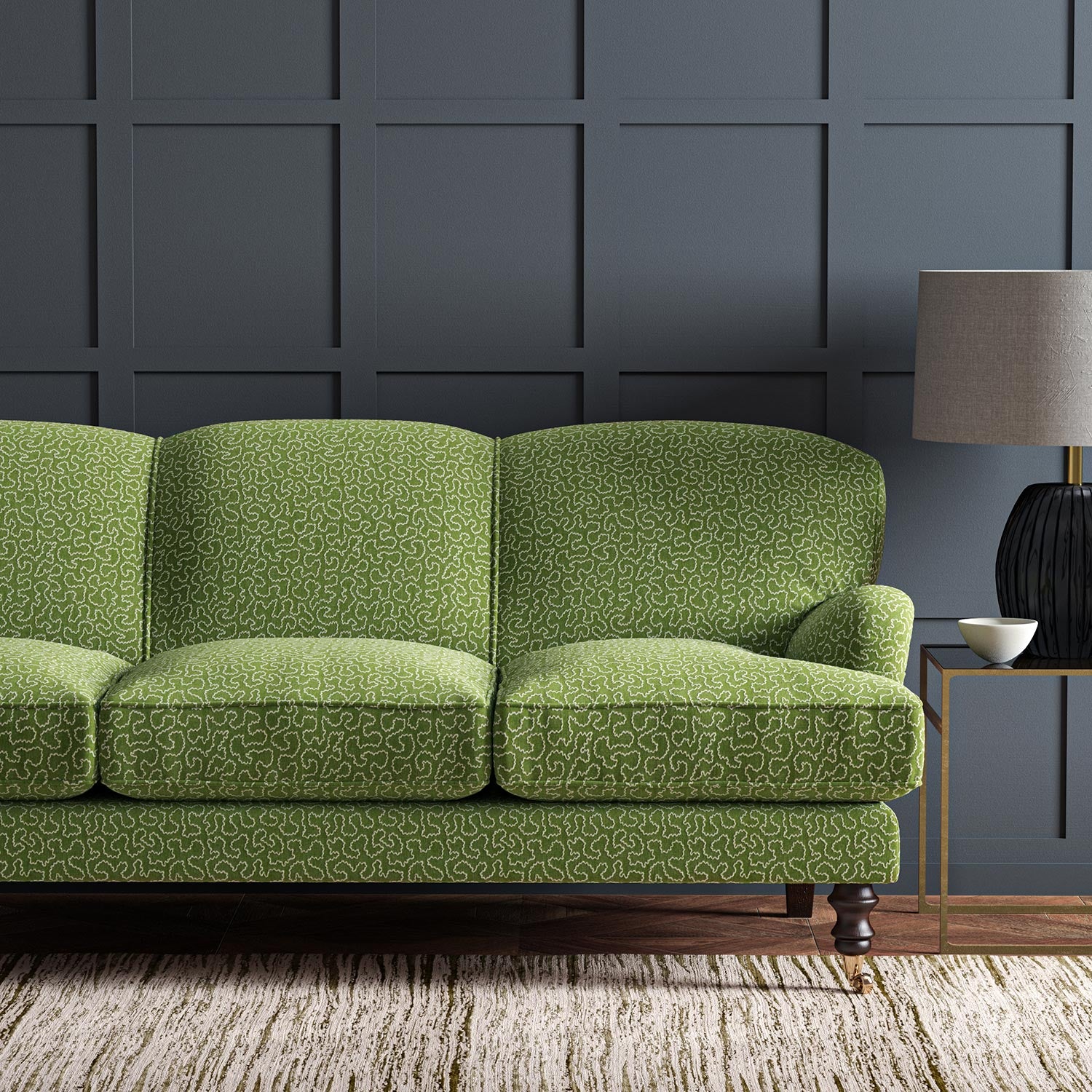 Sofa upholstered in a green and off-white woven fabric featuring a wavy pattern.