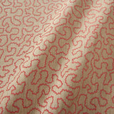 A woven fabric sample in pink and off-white featuring a wavy pattern.