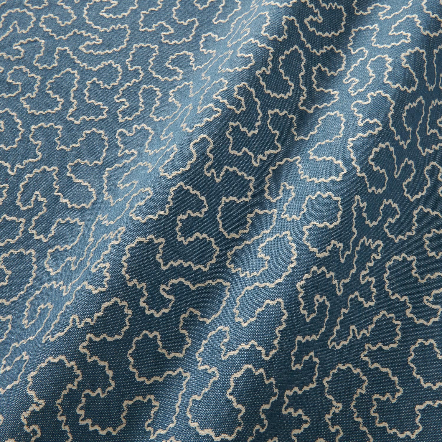 A woven fabric sample in blue and off-white featuring a wavy pattern.