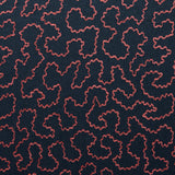 A woven fabric sample in blue and red featuring a wavy pattern.