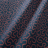 A woven fabric sample in blue and red featuring a wavy pattern.